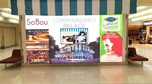 Commander's Palace Louis Armstrong airport signage